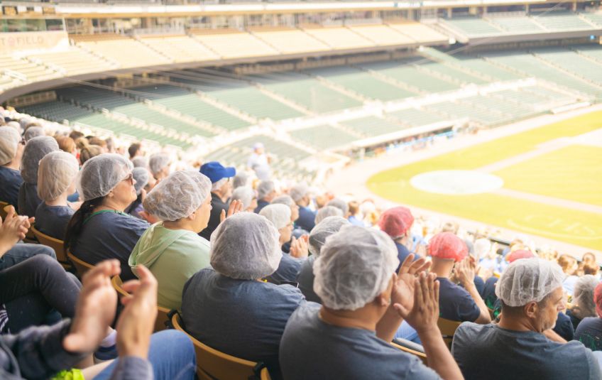 FMSC volunteers in hairnets at baseball stadium for MobilePack