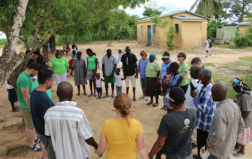 A group holds hands to pray