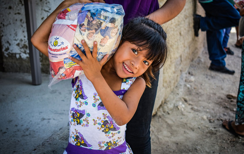 Girl in Guatemala holding FMSC food