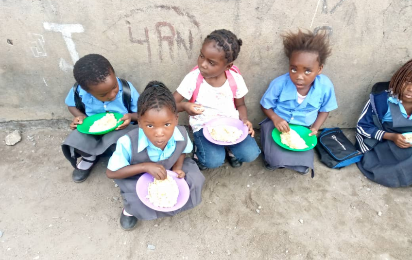 Kids eating at Free Baptist Community School