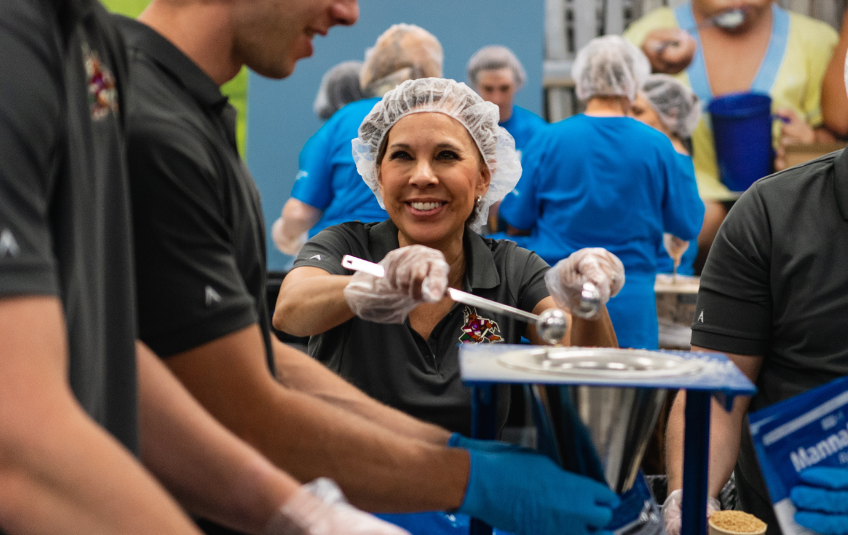 Woman packing meals at an FMSC MobilePack