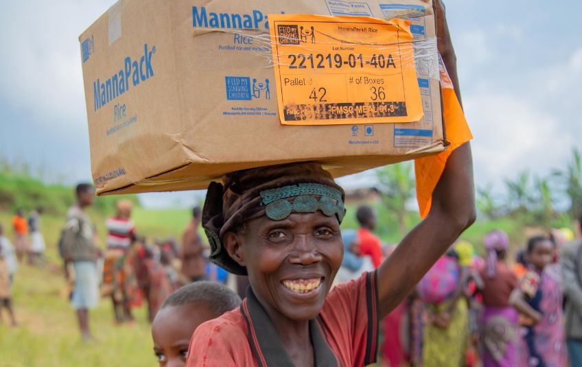 Woman holding MannaPack box on her head 