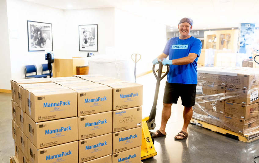 FMSC volunteer with a pallet of MannaPack boxes